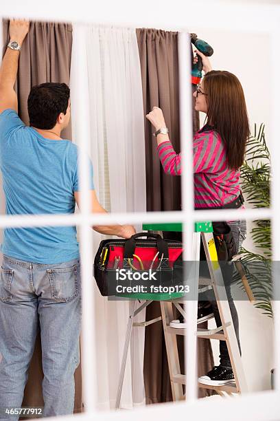 Home Improvement Diy Couple Installs Curtain In Home Tools Ladder Stock Photo - Download Image Now