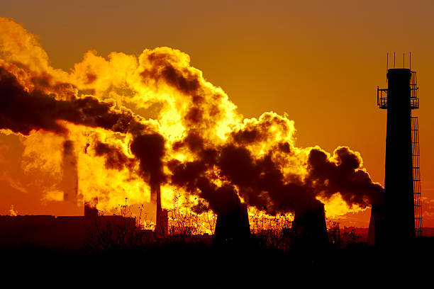 istock power plant smokestacks at sunset 465778328