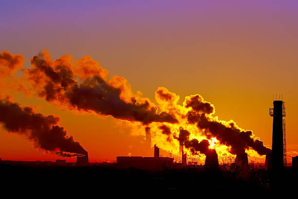 istock power plant smokestacks at sunset 465778650