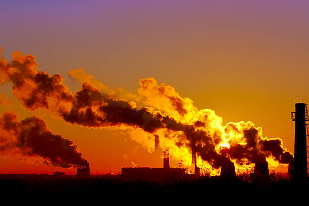 istock power plant smokestacks at sunset 465778682