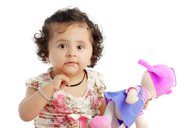 istock Baby girl with a colored soft toy 465781404