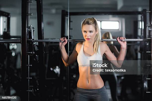 Girl Doing Exercise With Barbell In Gym Stock Photo - Download Image Now - Rebar, Gym, Health Club