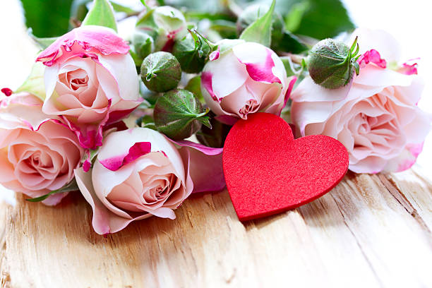 istock roses and heart are on a wood background 465786165