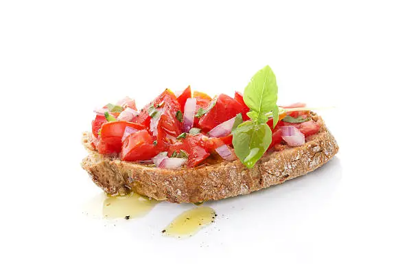 Delicious bruschetta with chopped tomatoes, onion and fresh herbs and olive oil. Culinary mediterranean eating.