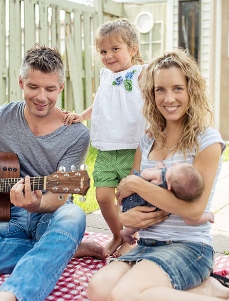 istock Father playing guitar on a family picnic 465786941