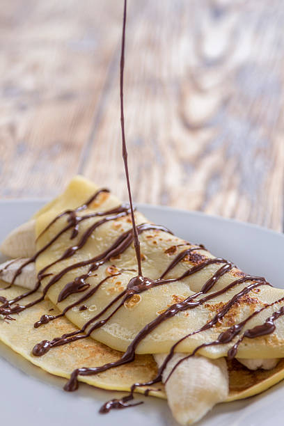 istock chocolate sauce pouring on crepe 465791574