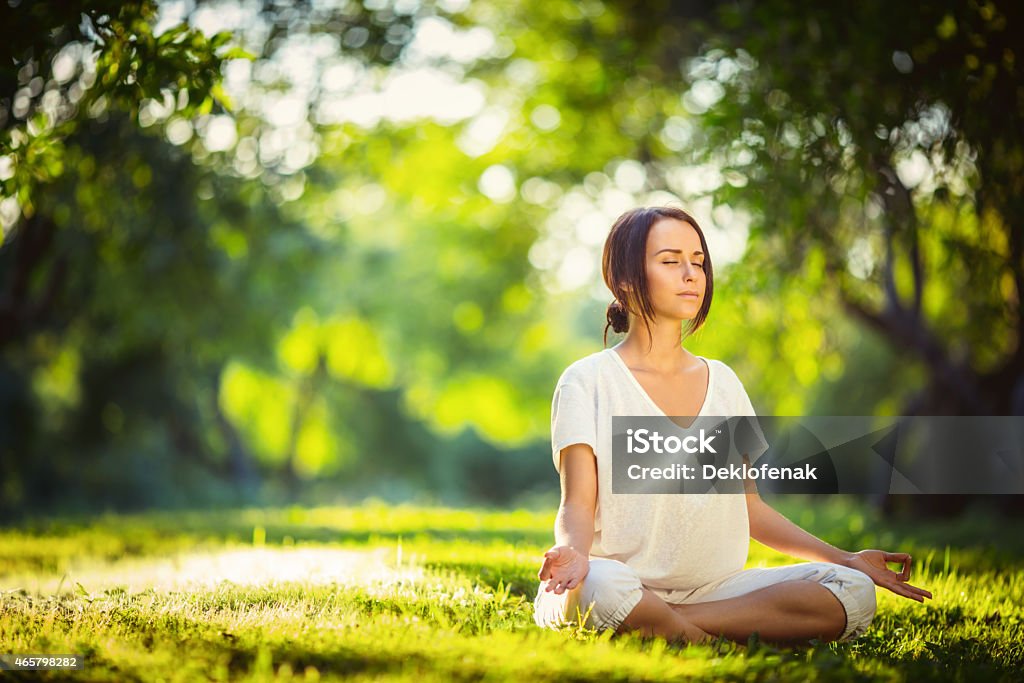 Time for yoga Young girl doing yoga in the park Yoga Stock Photo