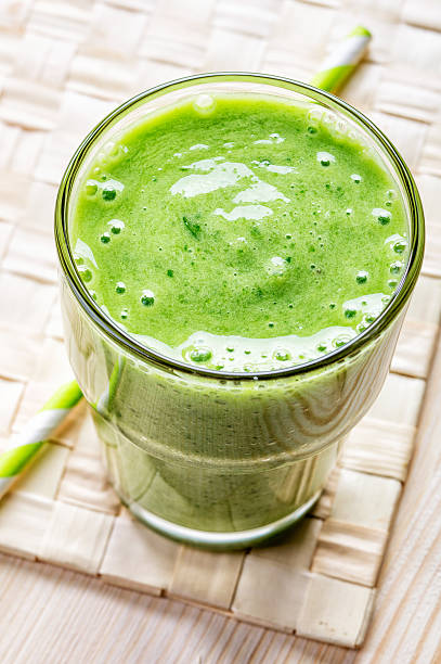 istock glass of green smoothie, top view 465801094