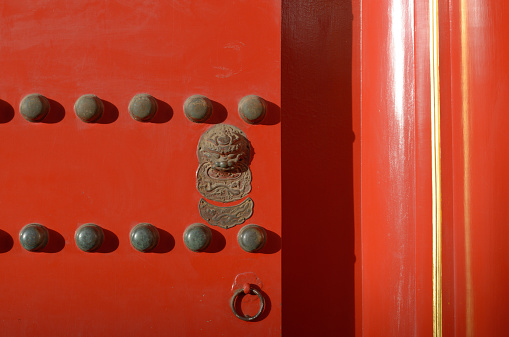 Partial of Chinese door, red painted, lion figure knob set and 2 rows of 9 pieces of half sphere shape from Chinese's belief.