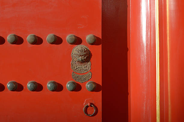 Door Partial of Chinese door, red painted, lion figure knob set and 2 rows of 9 pieces of half sphere shape from Chinese's belief. forbidden city beijing architecture chinese ethnicity stock pictures, royalty-free photos & images