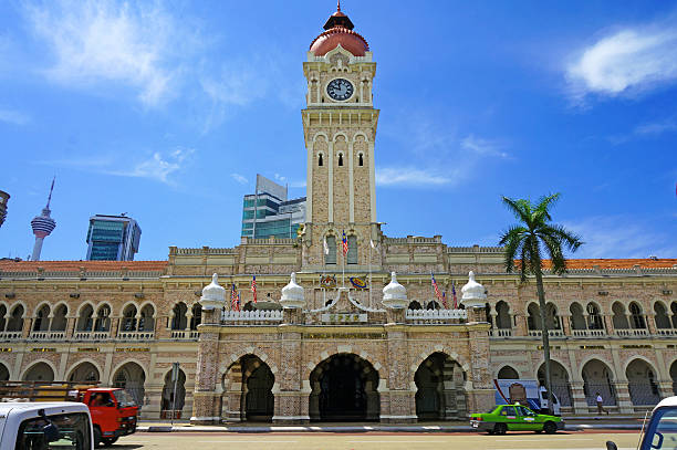 Sultan Abdul Samad Building Entrance of the Sultan Abdul Samad Building in Kuala Lumpur, Malaysia. Photo with blue sky background. merdeka square stock pictures, royalty-free photos & images