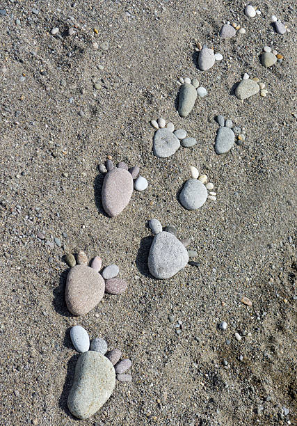 istock foot prints of stones 465825956
