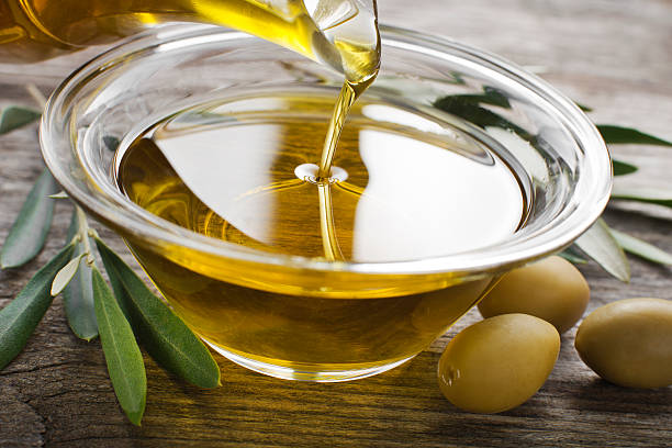 istock Pouring Olive oil in a bowl close-up 465826050