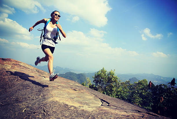istock hiking woman running on mountain peak 465826824