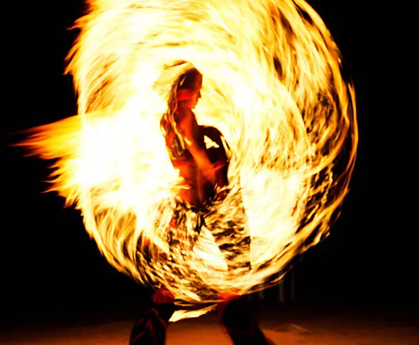 Fire dancer or fire eater performing