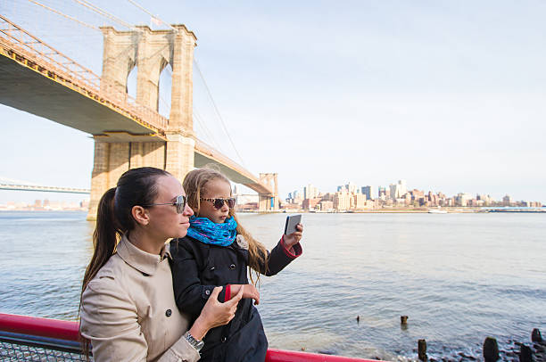 istock Mother and adorable daughter taking selfie 465830356
