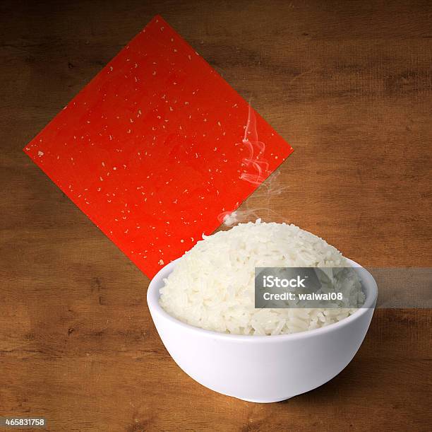 Bowl Of Cooked Fragrance Rice On Wood With Red Paper Stock Photo - Download Image Now