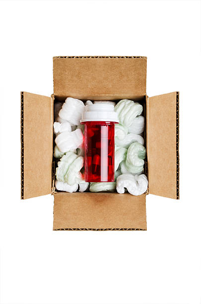 Overhead shot of red vial of medicine inside a packaged box stock photo