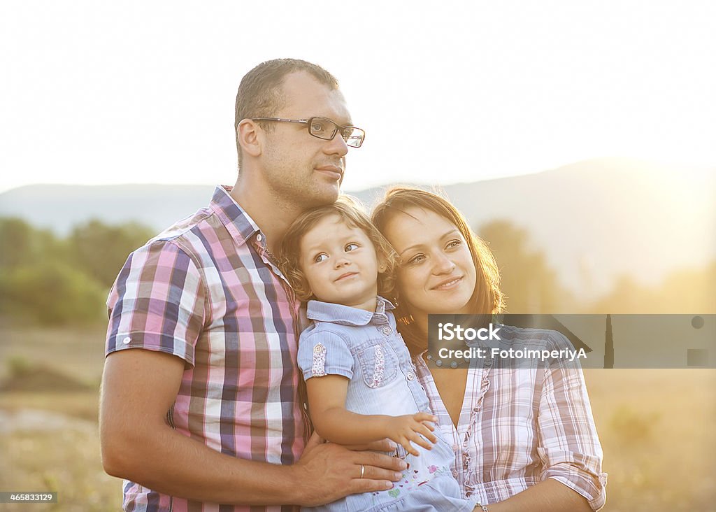 Happy family Happy mother, father and daughter in sunset Adult Stock Photo