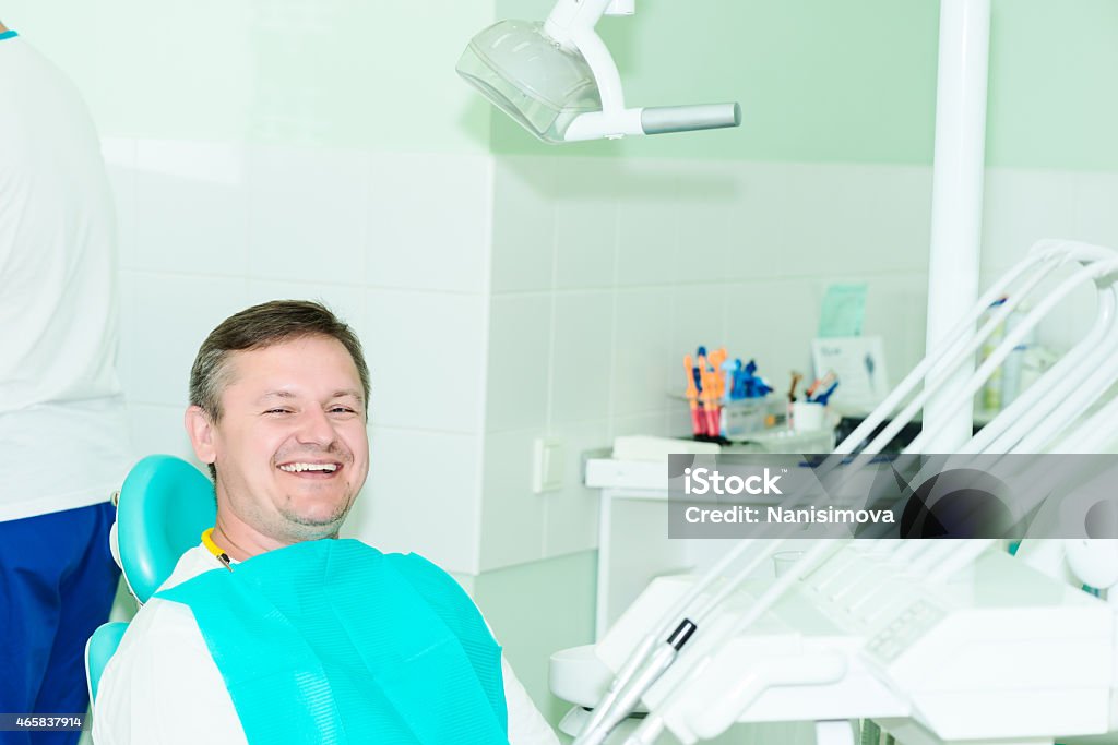 smiling patient looking at camera at the dentist office Image of happy smiling patient looking at camera at the dentist office 2015 Stock Photo