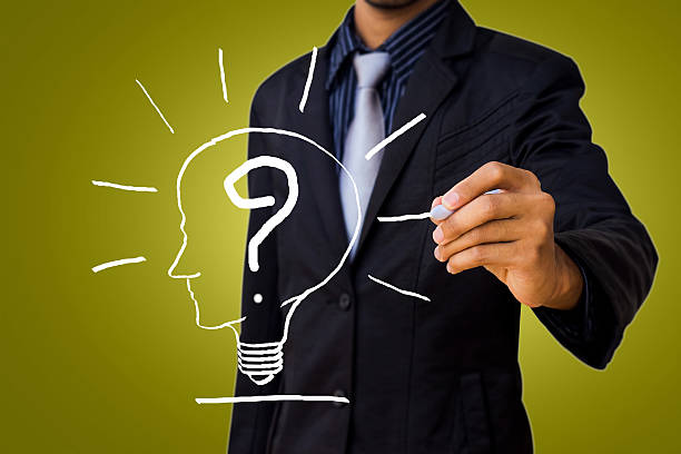 istock Drawing a question mark in the head lamp by businessman. 465840471