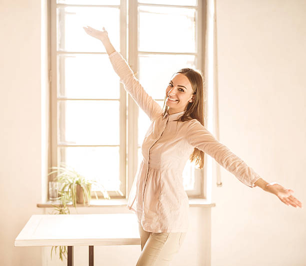 istock Young happy woman with her arms outstretched. 465840562