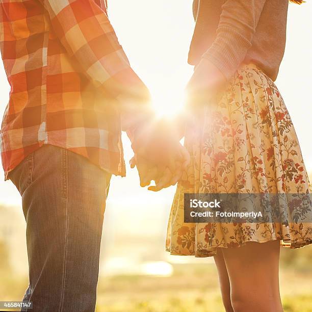 A Young Couple Facing Each Other Holding Hands Stock Photo - Download Image Now - Adult, Adults Only, Affectionate