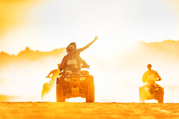 istock Friends driving quad bikes in the desert. 465843306
