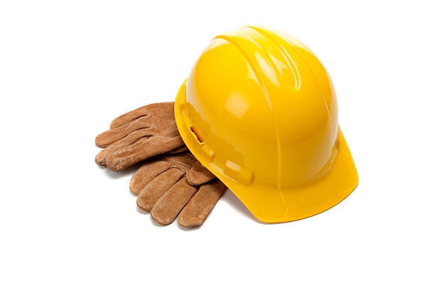 istock Yellow hard hat and leather work gloves on white 465843406