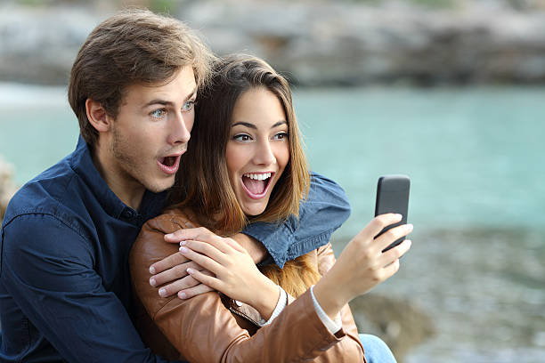 istock Shocked couple watching a smart phone on holidays 465843646