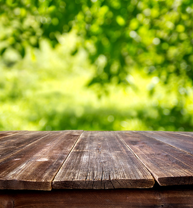 wooden table against defocused summer background