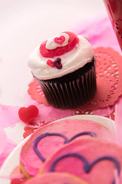 istock Valentines Day - pink cookies and cupcakes with hearts 465843932