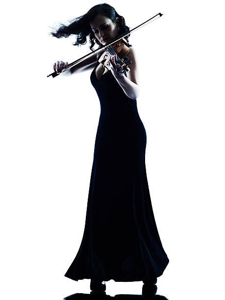 Violinist woman slihouette isolated one caucasian Violinist woman player playing violon studio slihouette isolated in white background violinist photos stock pictures, royalty-free photos & images