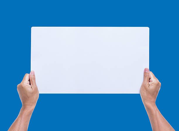 istock Hands holding blank paper isolated on blue background 465846160