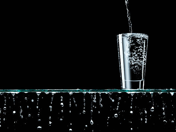 Pouring water Overflowing glass of water overflowing stock pictures, royalty-free photos & images