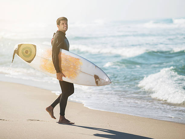 istock Smiling Latin American surfer on the beach. 465846690