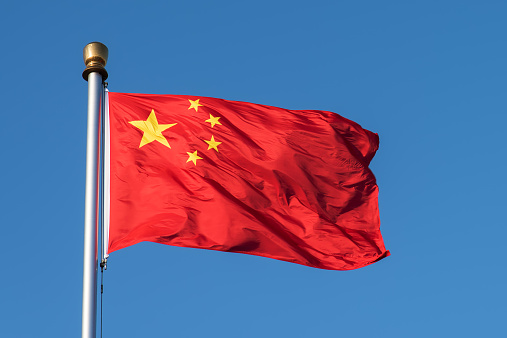 Flag of the Peoples Republic of China. The red represents the communist revolution; the five stars represent the unity of the Chinese people under the leadership of the Communist Party of China.