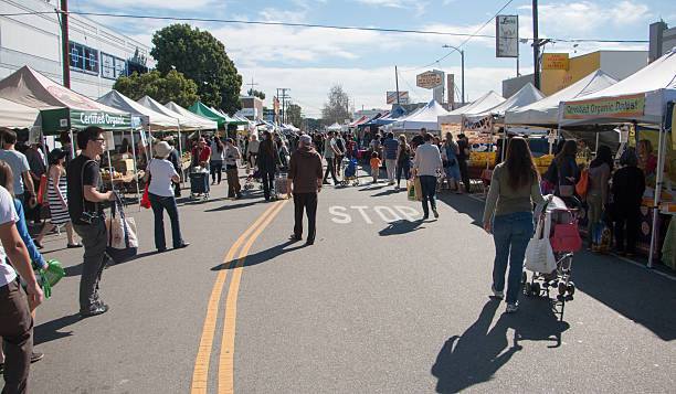 Crowded Farmers Market Many people shopping at a local farmers market in southern California. agricultural fair photos stock pictures, royalty-free photos & images