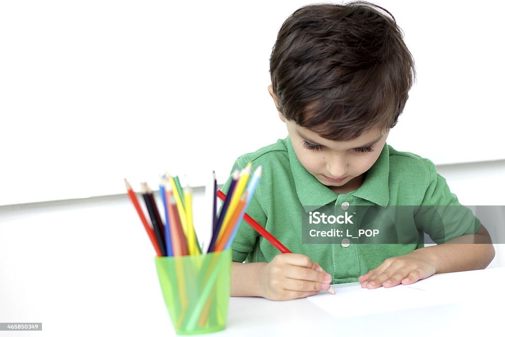 little boy drawing with colourful pencils little boy drawing on a paper with colourful pencils on a white background 2-3 Years Stock Photo