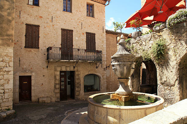 Town square with fountain and medieval houses in Saint Paul de Vence, one of the oldest towns in Provence, France, famous town of painters and galleries