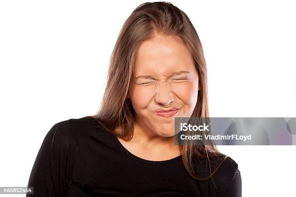 Young Woman With Sour Gesture Stock Photo - Download Image Now - Sour Taste, Human Face, Grimacing