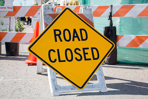 Road Closed Sign with Barricade in Background Road Closed Sign with Barricade in Background road closed sign horizontal road nobody stock pictures, royalty-free photos & images