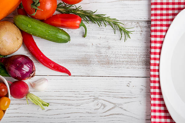 istock different vegetables, herbs on wood, plate kitchen towel, copy space 465855328