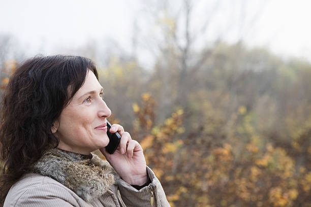 istock Woman Using Cellphone Outdoors 465858344