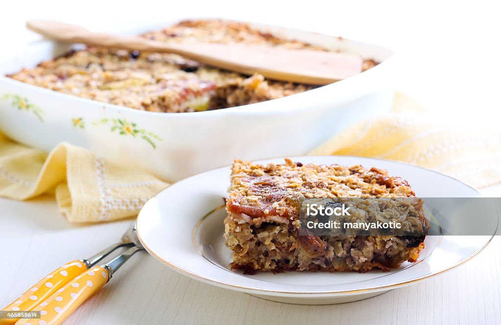 Fruity baked oatmeal Fruity baked oatmeal in baking tin on table 2015 Stock Photo