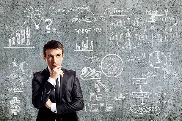 istock businessman in suit and business plan on grunge wall 465862189