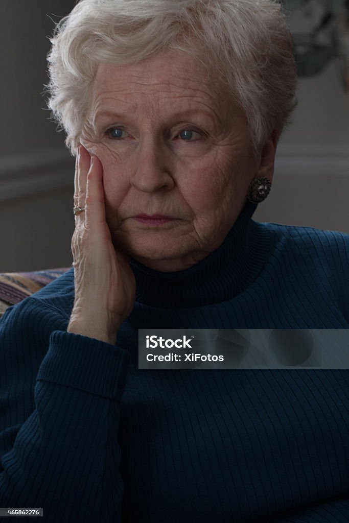 Senior blue Senior woman lost in deep thoughts 70-79 Years Stock Photo