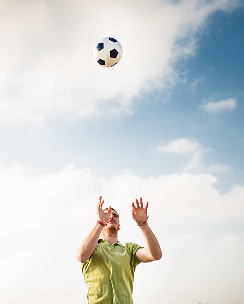 istock man playing volleyball with soccerball 465865494