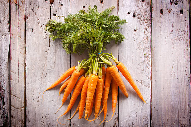 istock Bunch of Carrots on Rustic Wood 465869422