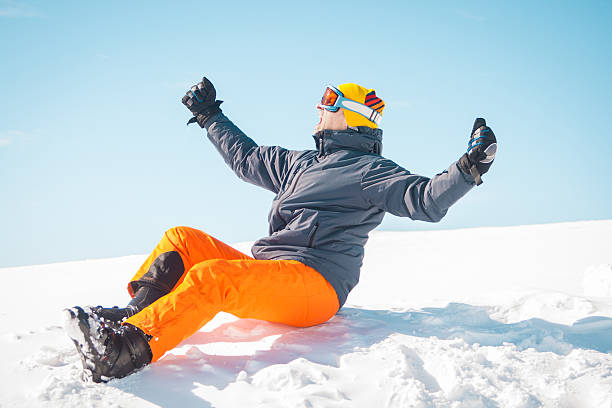 istock Excited male skier sitting on snow 465870718